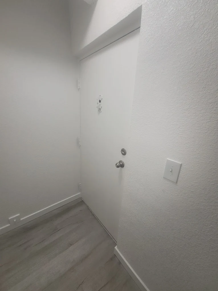 Clean interior hallway with new flooring and finished walls