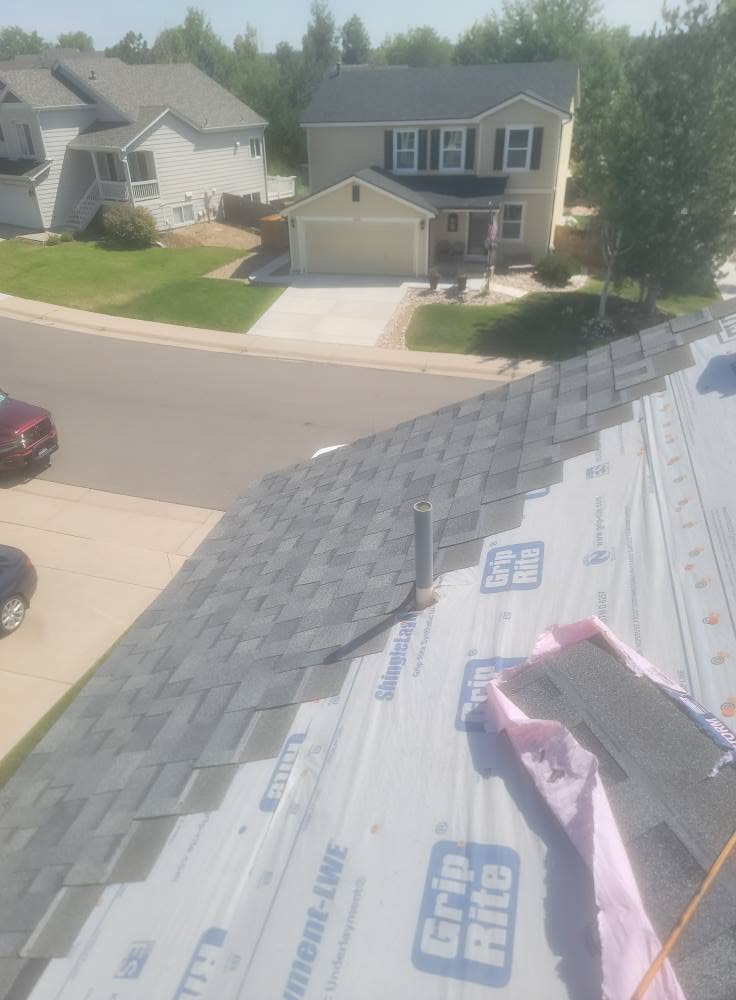 Roof replacement in progress with premium underlayment and shingle bundles